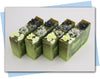 Green and black swirled soaps with yellow to black ombre flowers on top