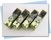 Green and black swirled soaps with yellow to black ombre flowers on top