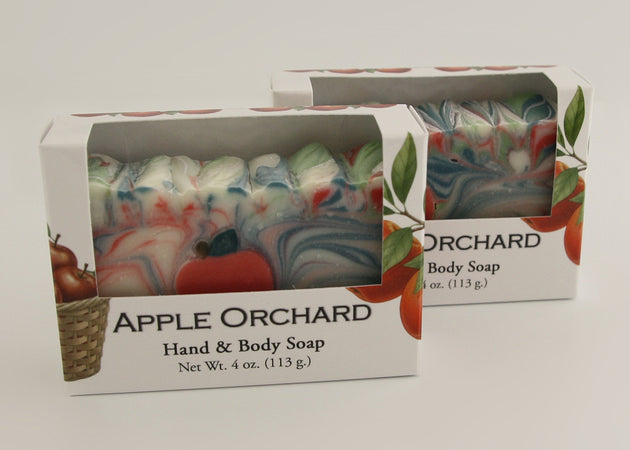 Bars of soap in custom packaging with apple and swirl design