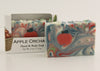 Bars of soap in custom packaging with apple and swirl design