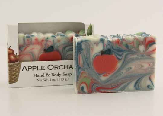Bars of soap in custom packaging with apple and swirl design