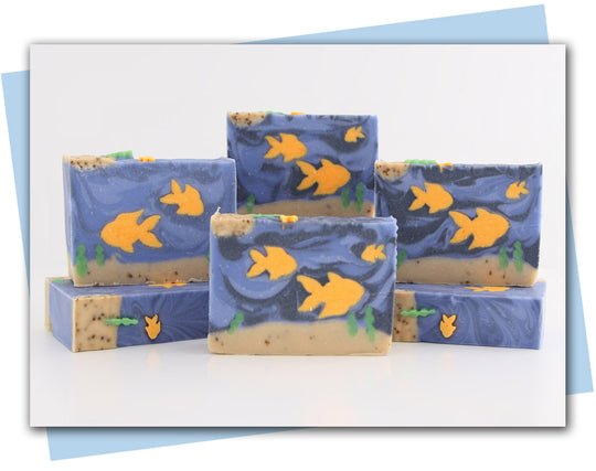 Bars of soap with goldfish swimming in an ocean