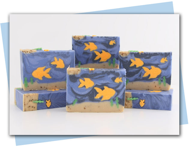 Bars of soap with goldfish swimming in an ocean