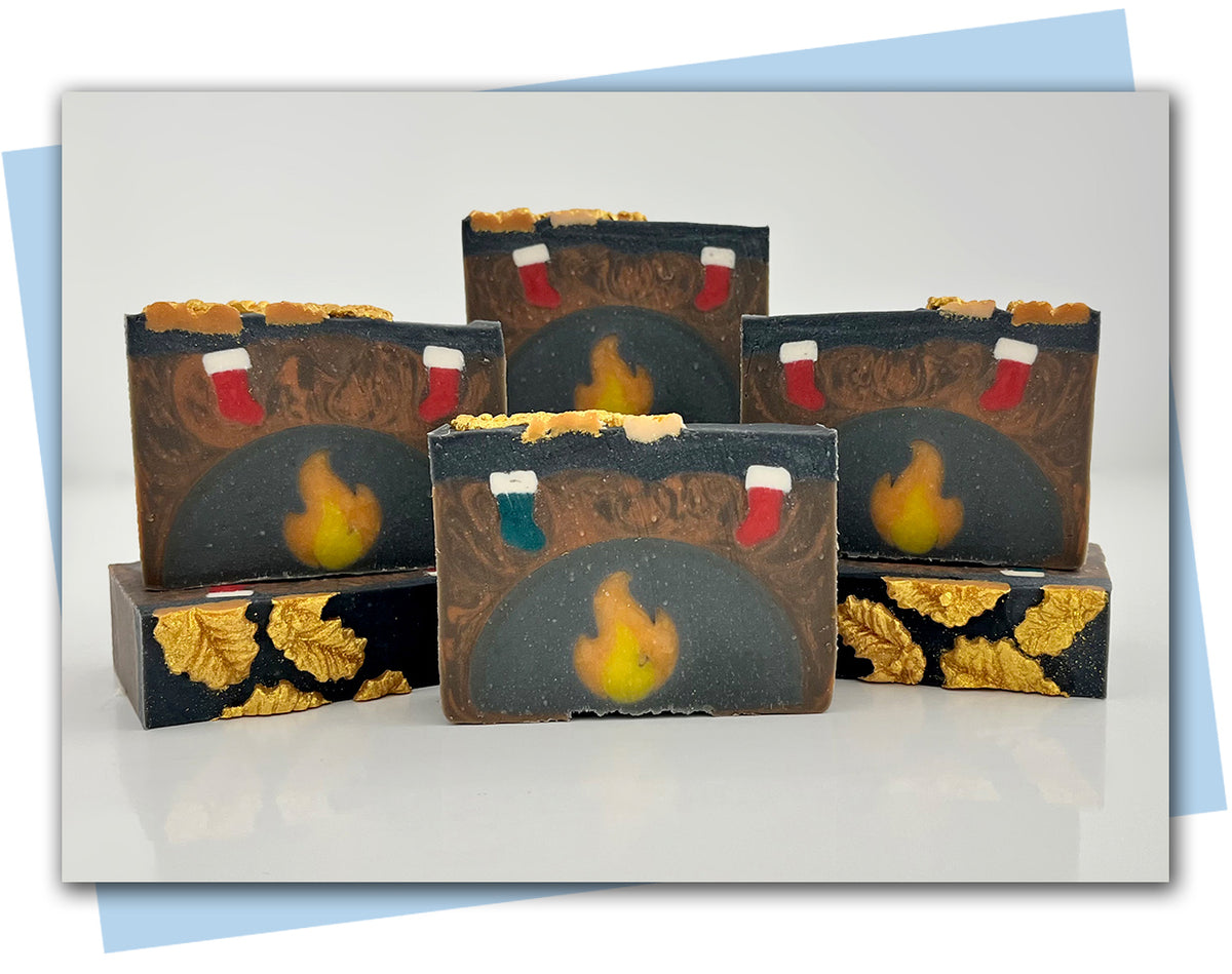 Soaps designed to look like a firelplace with a mantel with stockings hanging over the fire
