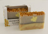 Bars of soap in custom packaging with bee soap design and honey comb pattern on the top of the bar