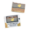 A bar of Honey Nectar hand and body soap shown both unwrapped and in its retail box. The soap has a rustic, jagged top edge and is layered in shades of gray, beige, and light brown, with a yellow wax butterfly in the center.