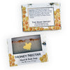 Two packages of The Soap Artist Honey Nectar Hand & Body Soap shown on a white background, one closed and one open to reveal the soap bar inside.