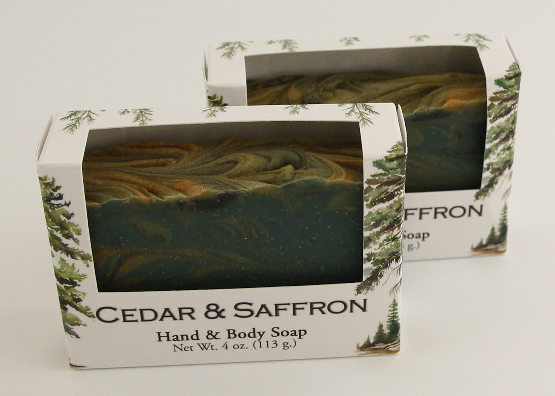 Bars of soap in custom packaging with swirl design green gold and black