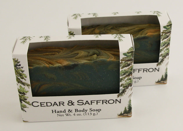 Bars of soap in custom packaging with swirl design green gold and black