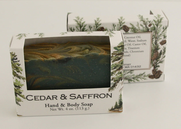 Bars of soap in custom packaging with swirl design green gold and black