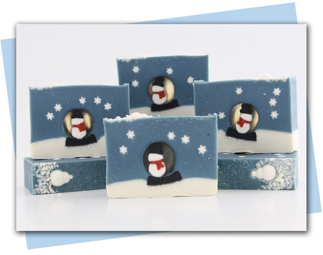 Bars of soap with a snowman in a snow globe and snowflakes falling around him