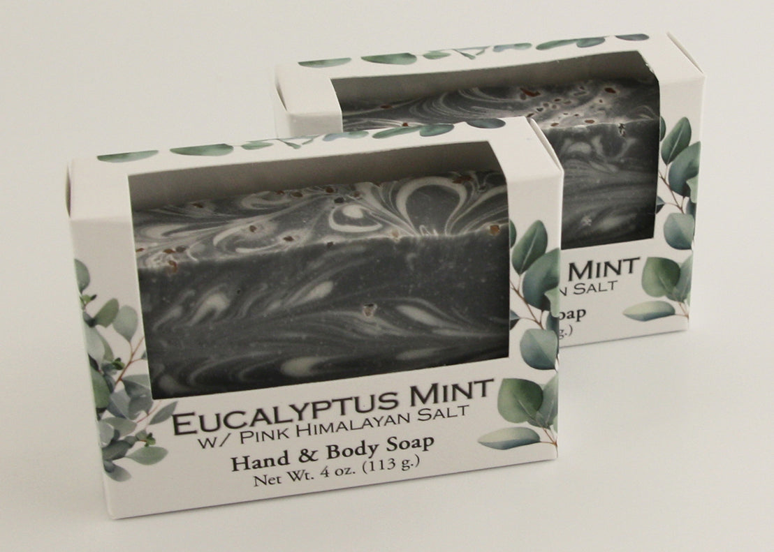 Bars of soap in custom packaging with black and white swirl design