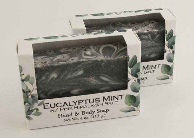 Bars of soap in custom packaging with black and white swirl design