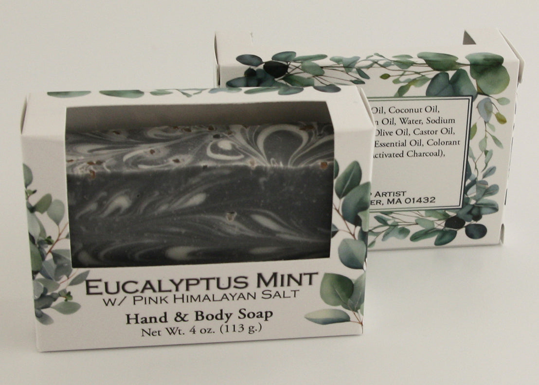 Bars of soap in custom packaging with black and white swirl design