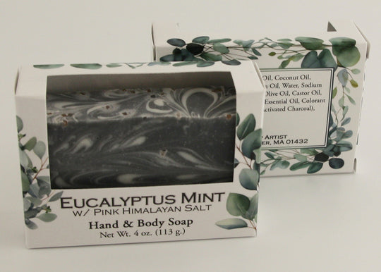 Bars of soap in custom packaging with black and white swirl design
