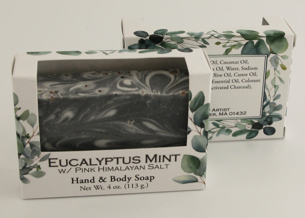 Bars of soap in custom packaging with black and white swirl design