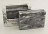 Bars of soap in custom packaging with black and white swirl design