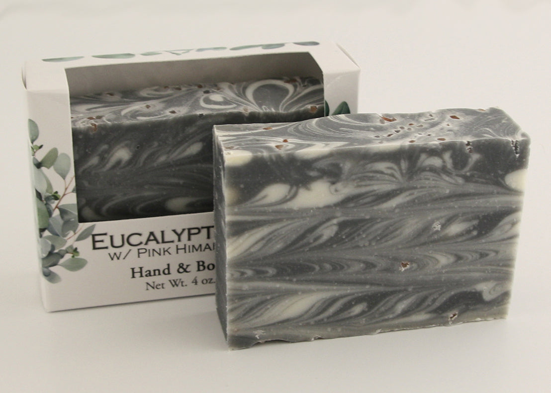 Bars of soap in custom packaging with black and white swirl design