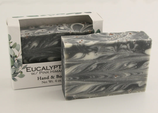 Bars of soap in custom packaging with black and white swirl design