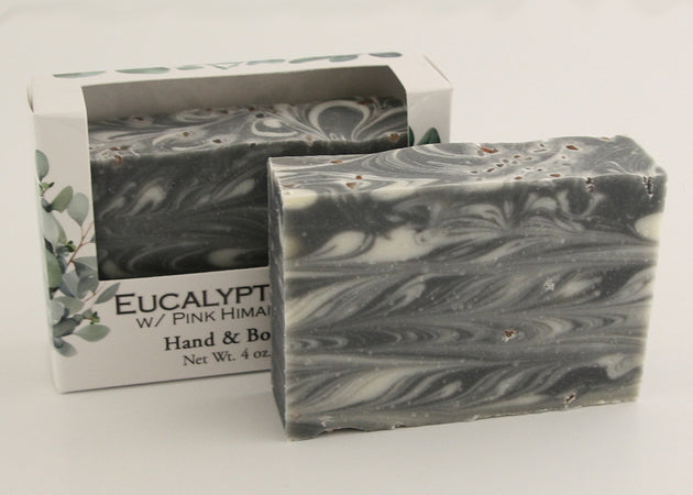Bars of soap in custom packaging with black and white swirl design