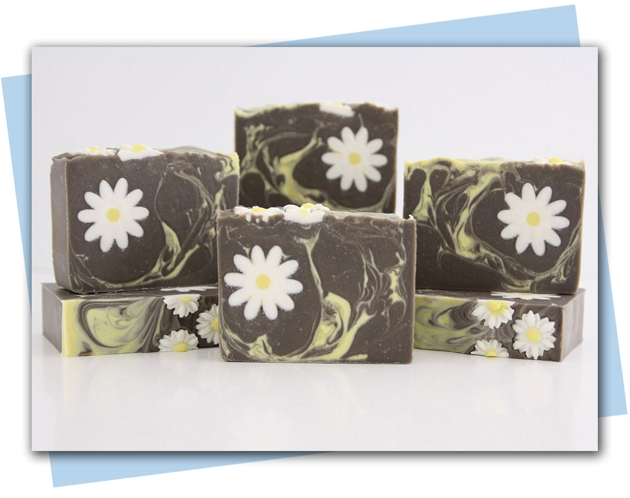 brown bars of soap with a yellow swirl and a white daisy embeds