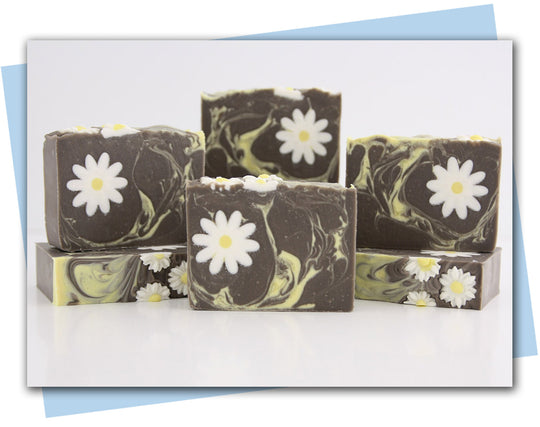 brown bars of soap with a yellow swirl and a white daisy embeds