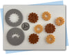 two gear extruder discs and a stamp.
