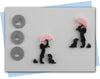 Girl holding umbrella over her head with dog at her feel extruder disc set and tuff or grass discs