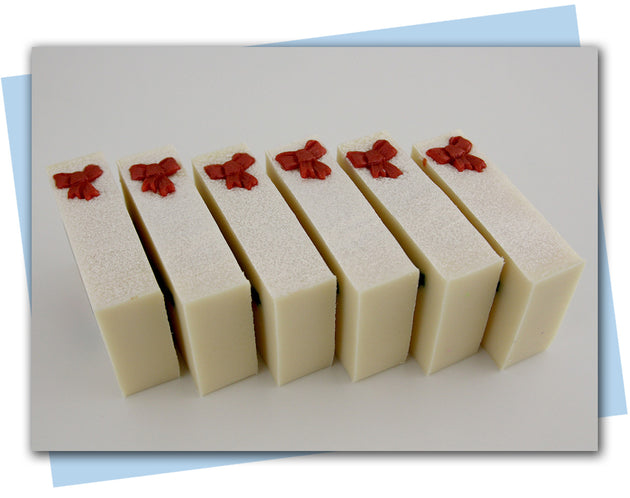 bars of soap with holly berries top with red bows