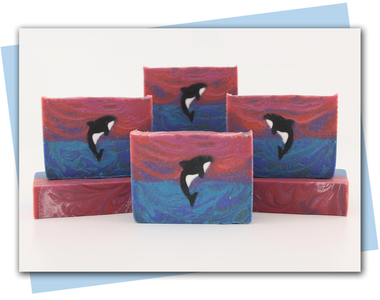 Bar of soap with an orca jumping out of the ocean into a sunset