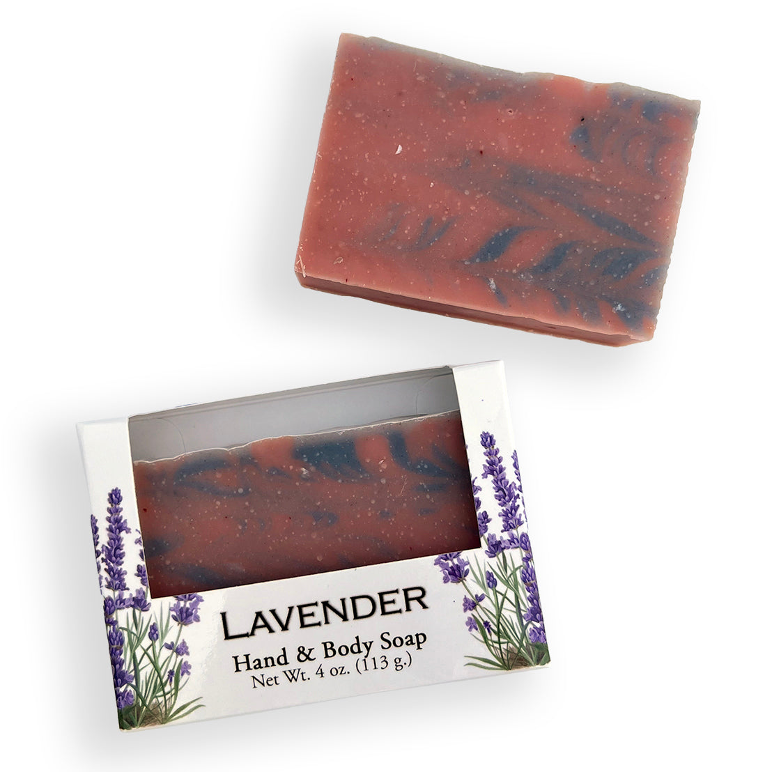 A handcrafted lavender soap bar with dark swirls, shown both standing upright and in its open retail box. The packaging features a clear window displaying the soap and a white label with purple lavender illustrations and the text 'LAVENDER Hand & Body Soap'.