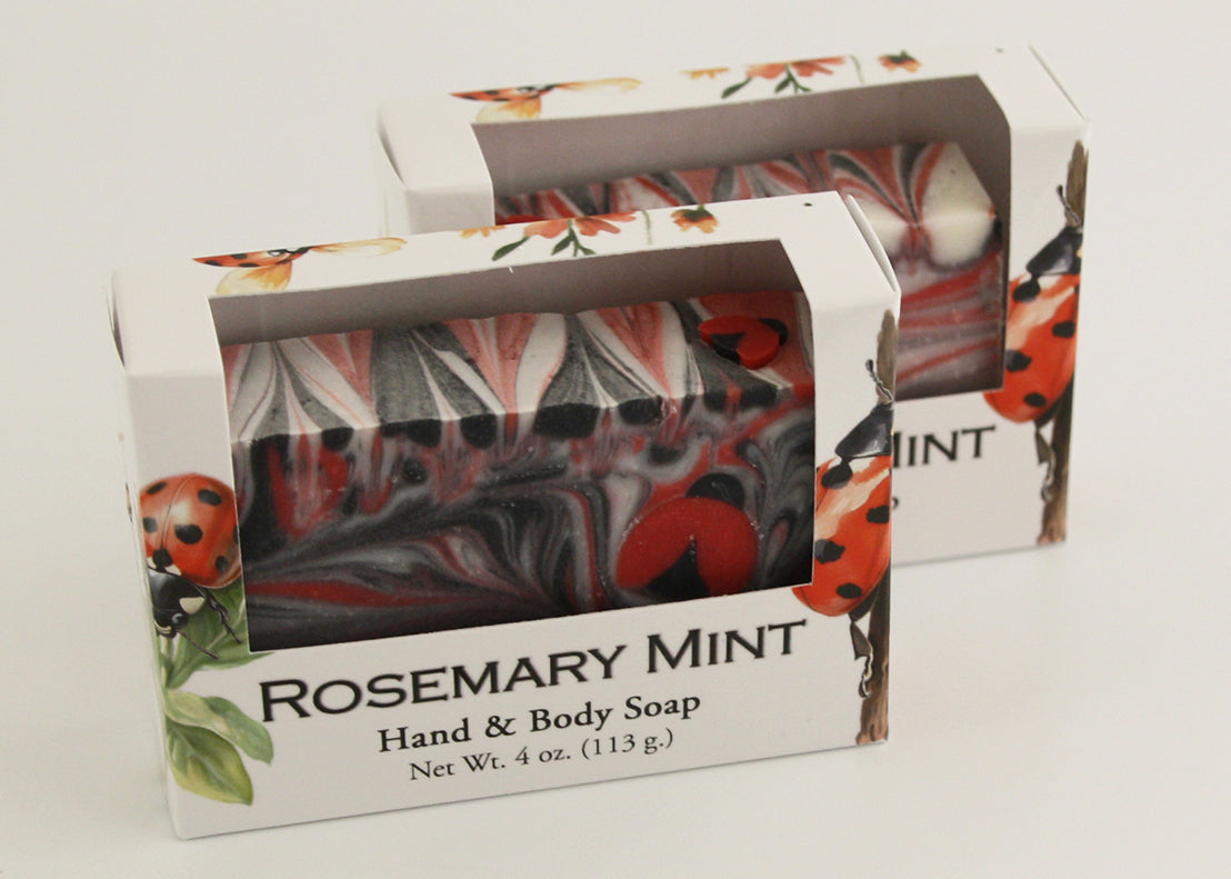 Bars of soap in custom packaging with ladybug embed and swirl design