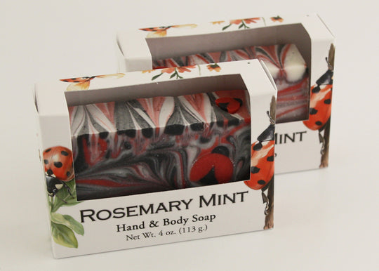 Bars of soap in custom packaging with ladybug embed and swirl design