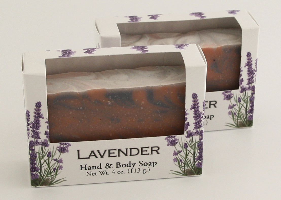 Bars of soap in custom packaging with rose clay and indigo powder swirl design