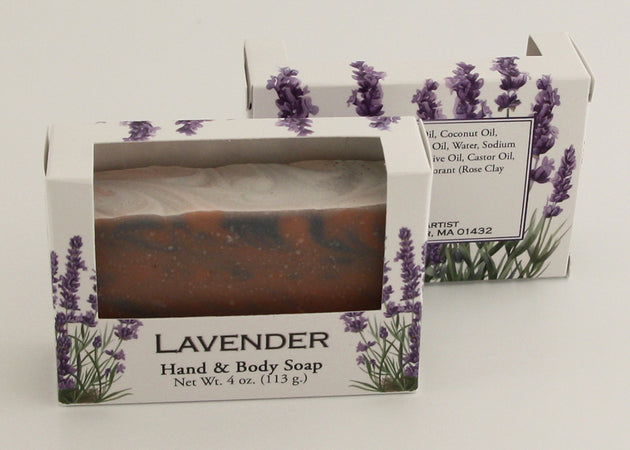 Bars of soap in custom packaging with rose clay and indigo powder swirl design