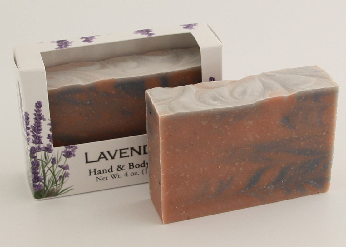 Bars of soap in custom packaging with rose clay and indigo powder swirl design