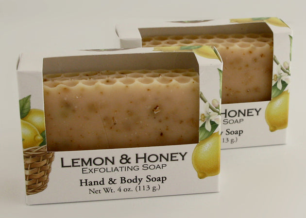 Bars of soap in custom packaging with lemon peel and a honey comb top design