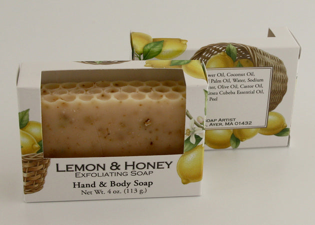 Bars of soap in custom packaging with lemon peel and a honey comb top design