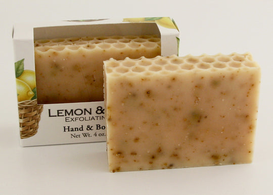 Bars of soap in custom packaging with lemon peel and a honey comb top design