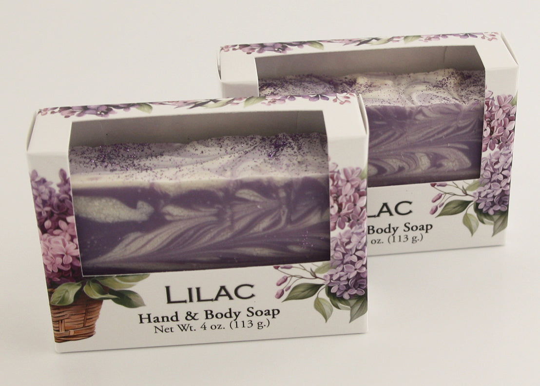 Bars of soap in custom packaging with purple and white  swirl design