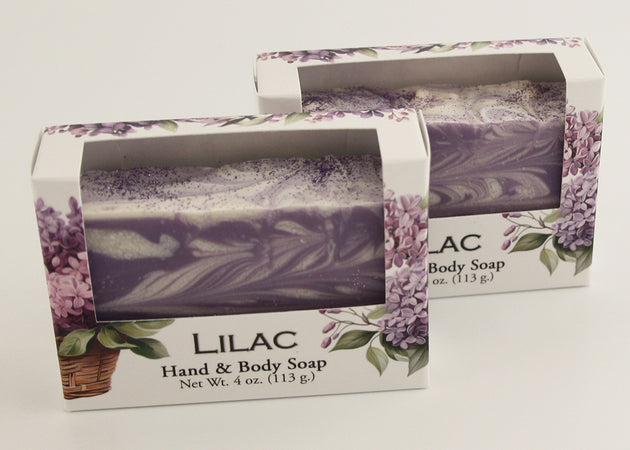 Bars of soap in custom packaging with purple and white  swirl design