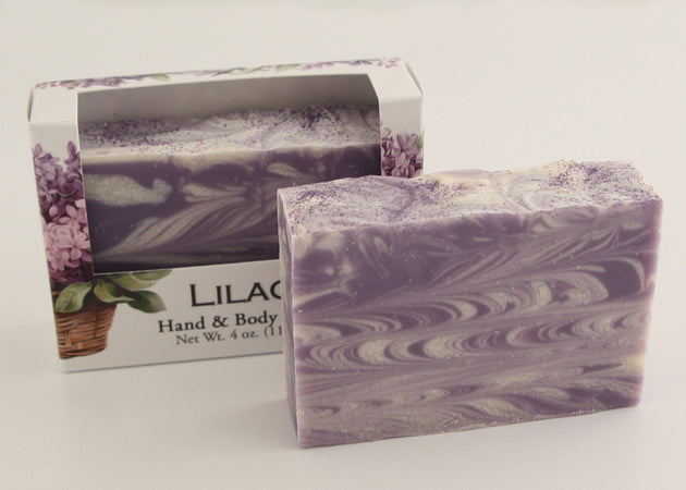 Bars of soap in custom packaging with purple and white  swirl design