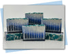 Bars of soap in a black to blue to white ombre design with a fence stamped on the face and vines and leaves decorating the top of the bar.