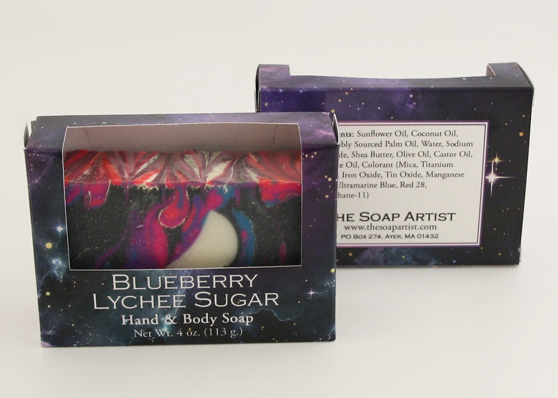 Bars of soap in custom packaging with moon embed and swirl design in black and neon colors