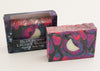 Bars of soap in custom packaging with moon embed and swirl design in black and neon colors
