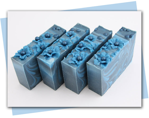 Blue flower tops with blue and black ombre swirl bars of soap