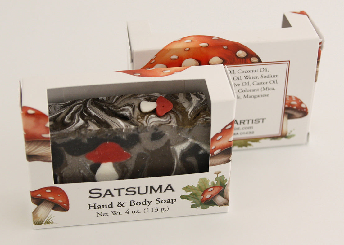 Bars of soap in custom packaging with with mushroom soap embed and swirl design