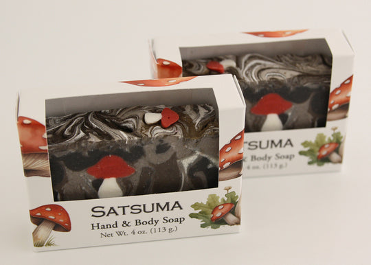 Bars of soap in custom packaging with with mushroom soap embed and swirl design