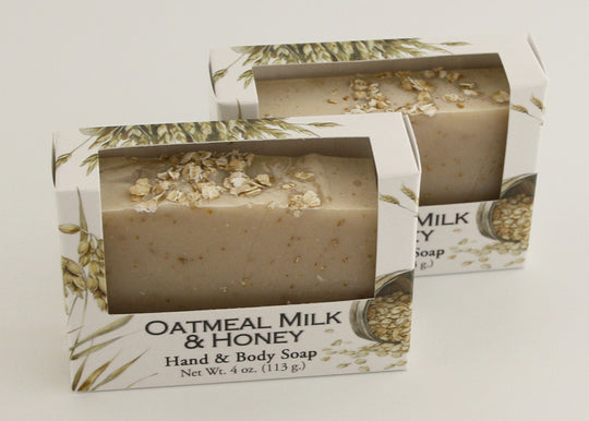 Bars of soap in custom packaging with oatmeal and milk brown bar design