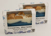 Bars of soap in custom packaging with seashells on top and ocean blue design for the bar